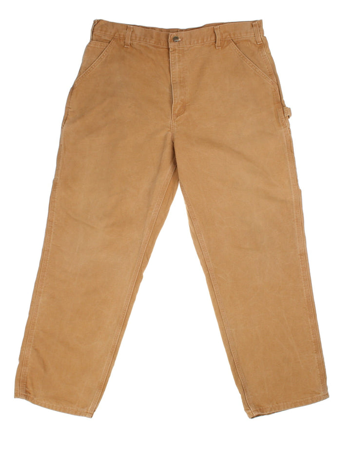 Carhartt Carpenter Jeans in a tan colourway with multiple pockets and leather logo on the back pocket.