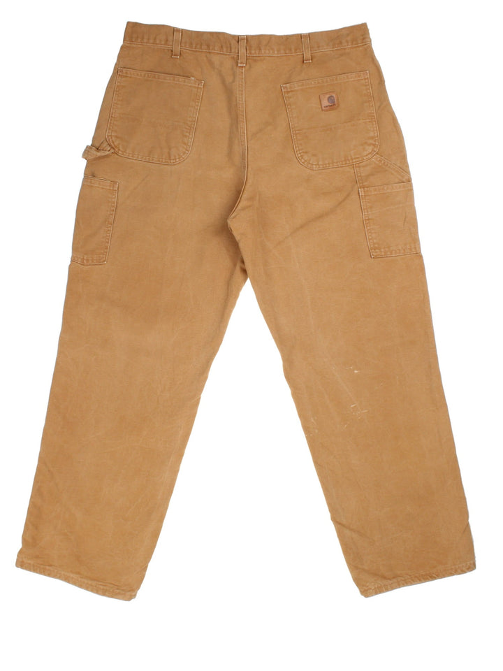 Carhartt Carpenter Jeans in a tan colourway with multiple pockets and leather logo on the back pocket.