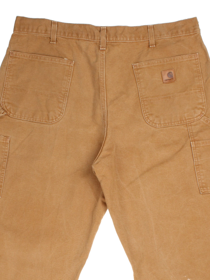 Carhartt Carpenter Jeans in a tan colourway with multiple pockets and leather logo on the back pocket.