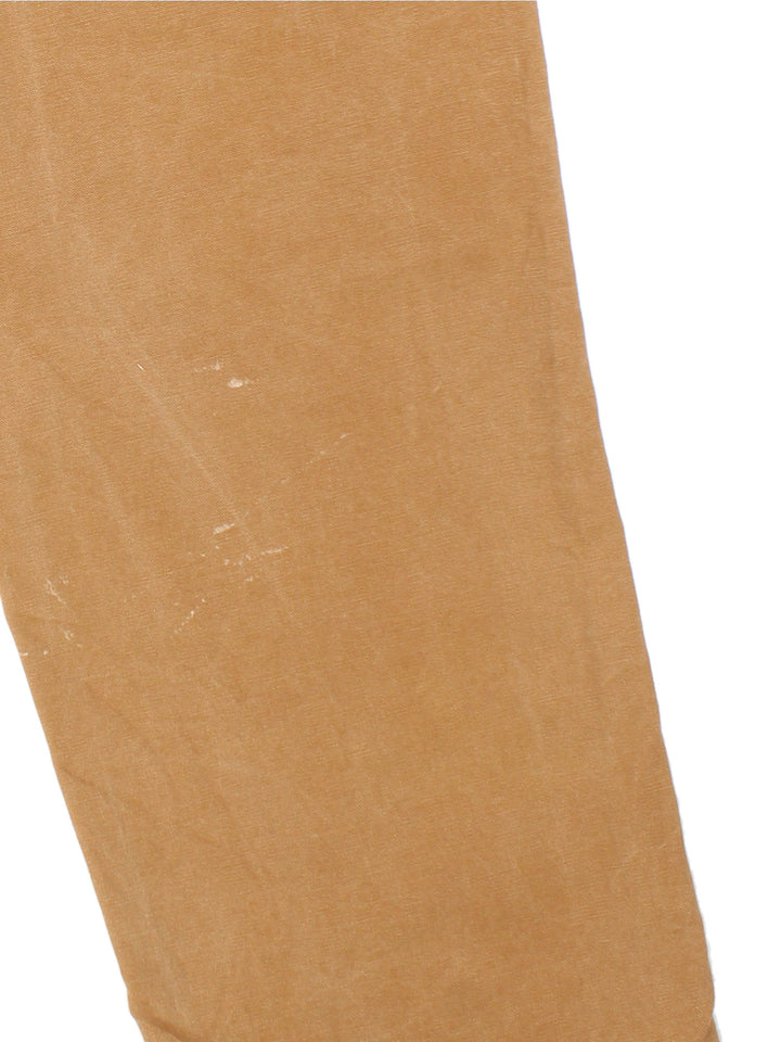Carhartt Carpenter Jeans in a tan colourway with multiple pockets and leather logo on the back pocket.
