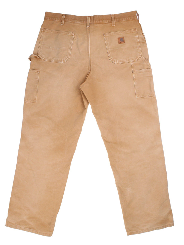 Carhartt Carpenter Jeans in a brown colourway with multiple pockets and leather logo on the back pocket.