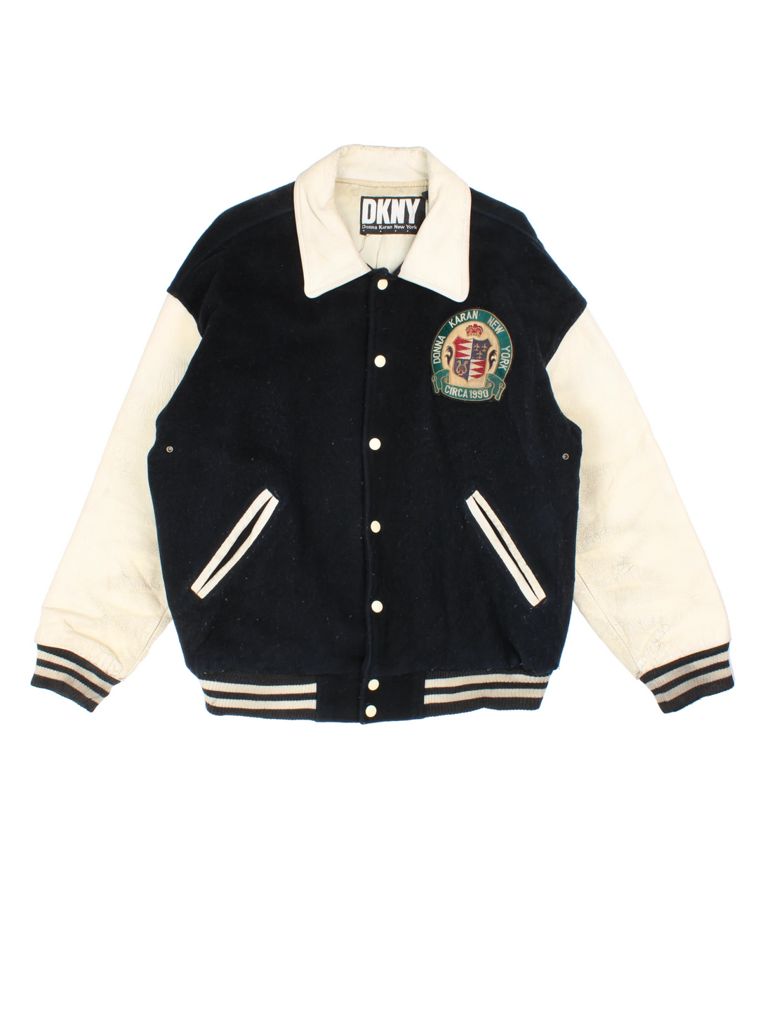 Vintage 90's DKNY black and white varsity jacket with wool body and leather sleeves, features embroidered badges and large spell-out motif on the back 