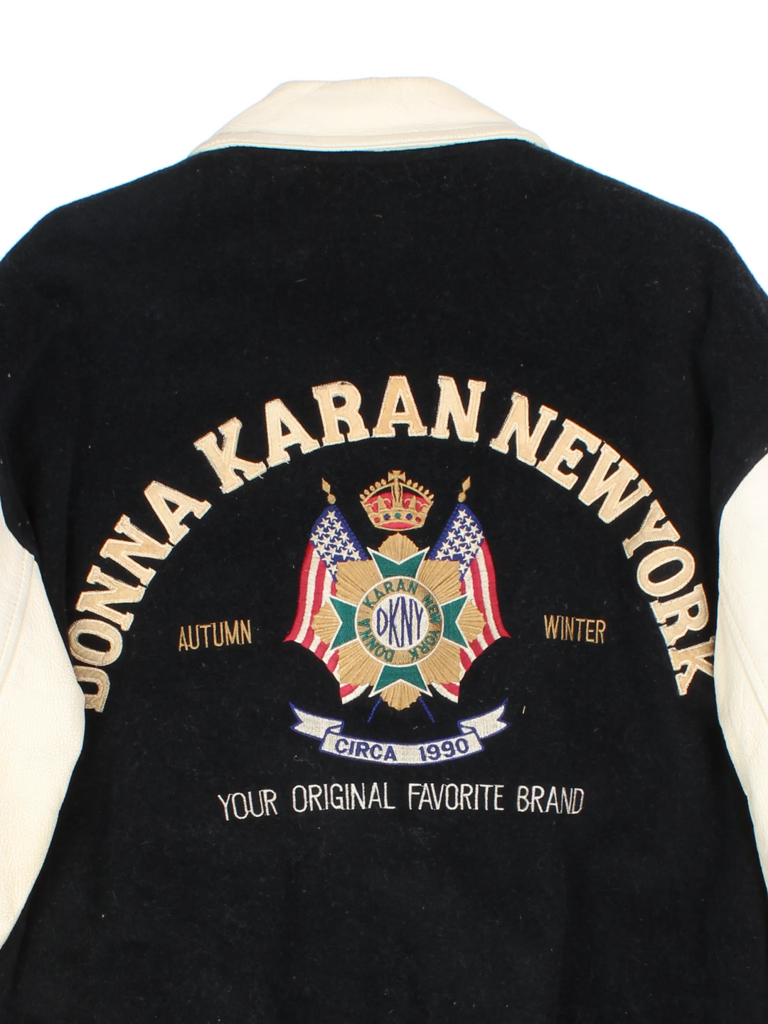 Vintage 90's DKNY black and white varsity jacket with wool body and leather sleeves, features embroidered badges and large spell-out motif on the back 