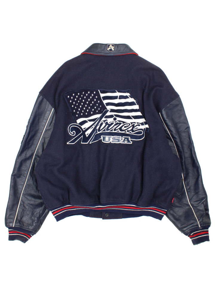 Vintage Avirex USA navy blue Varsity Jacket, embroidered badges on front, sleeve, and back. 