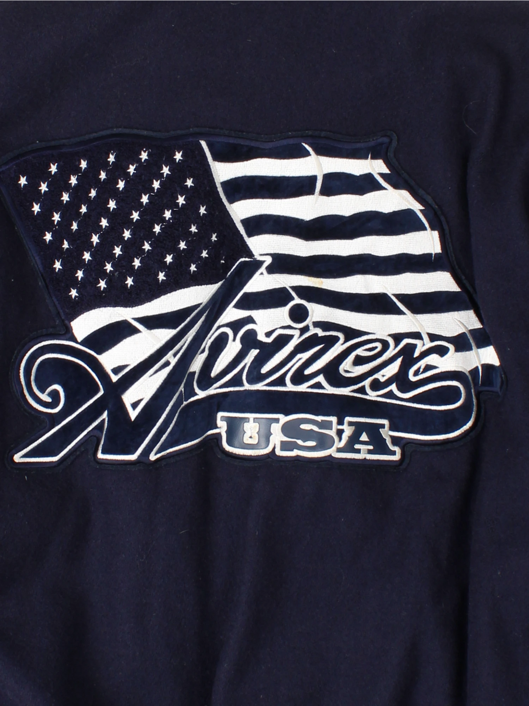 Vintage Avirex USA navy blue Varsity Jacket, embroidered badges on front, sleeve, and back. 