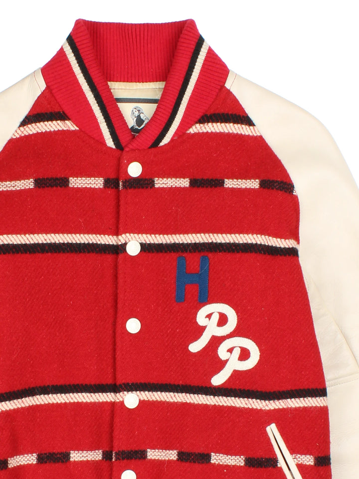 Vintage Hysteric Glamour varsity jacket in a red and cream colourway. The jacket has cream leather sleeves, press studs to close and jetted pockets on the front panels. The jacket is lined with a quilted fabric. and on the back there is a large chain stitched graphic reading 'Hysteric Performance Products'. Hysteric Glamour is a Japanese Streetwear brand, founded in 1984 by artist Nobuhiko Kitamura. 