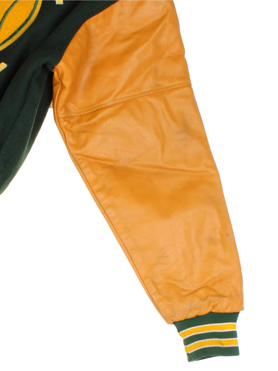 Vintage 2000 N.H.H.S Varsity Jacket in a green/yellow colourway. Features embroidered badges on front and embroidered spell-out on the back. Buttons up and has side pockets, insulated with quilted lining.