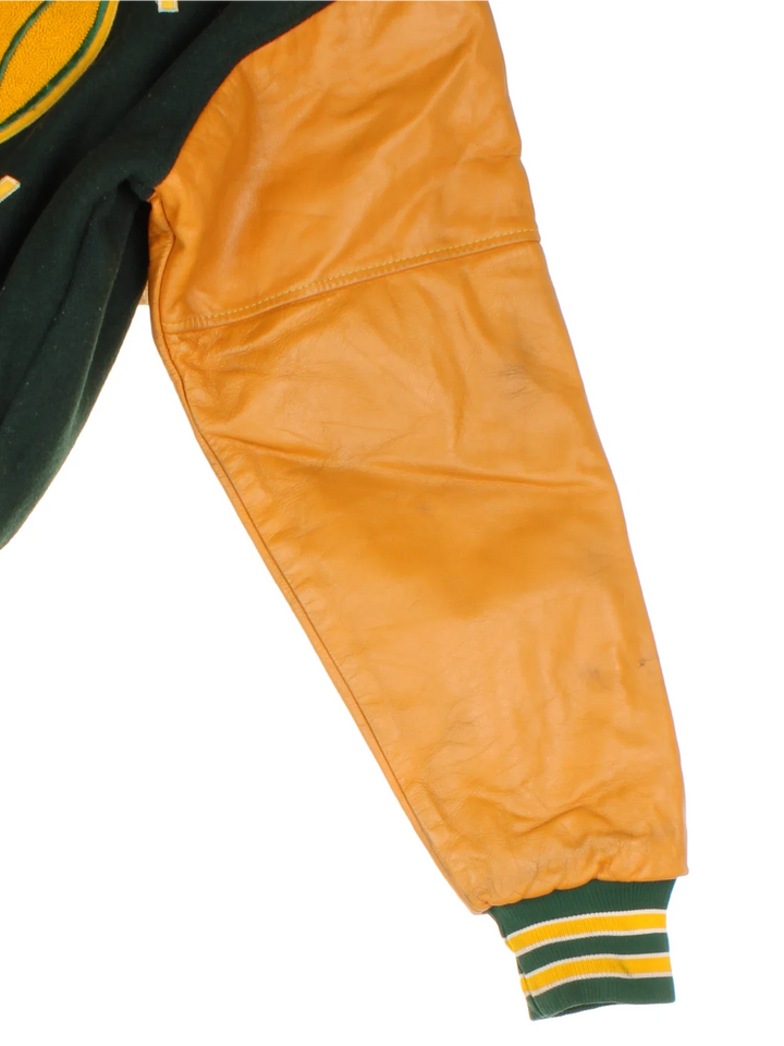 Vintage 2000 N.H.H.S Varsity Jacket in a green/yellow colourway. Features embroidered badges on front and embroidered spell-out on the back. Buttons up and has side pockets, insulated with quilted lining.