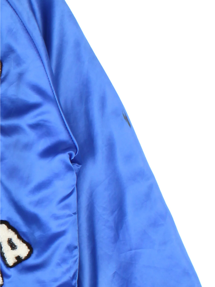 Vintage Ravenna Deer Varsity Jacket in a blue colourway. Buttons up and has side pockets, quilted lining, and has the logos embroidered on the front and big deer garphic on the back.
