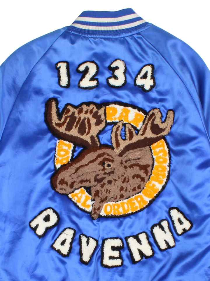 Vintage Ravenna Deer Varsity Jacket in a blue colourway. Buttons up and has side pockets, quilted lining, and has the logos embroidered on the front and big deer garphic on the back.