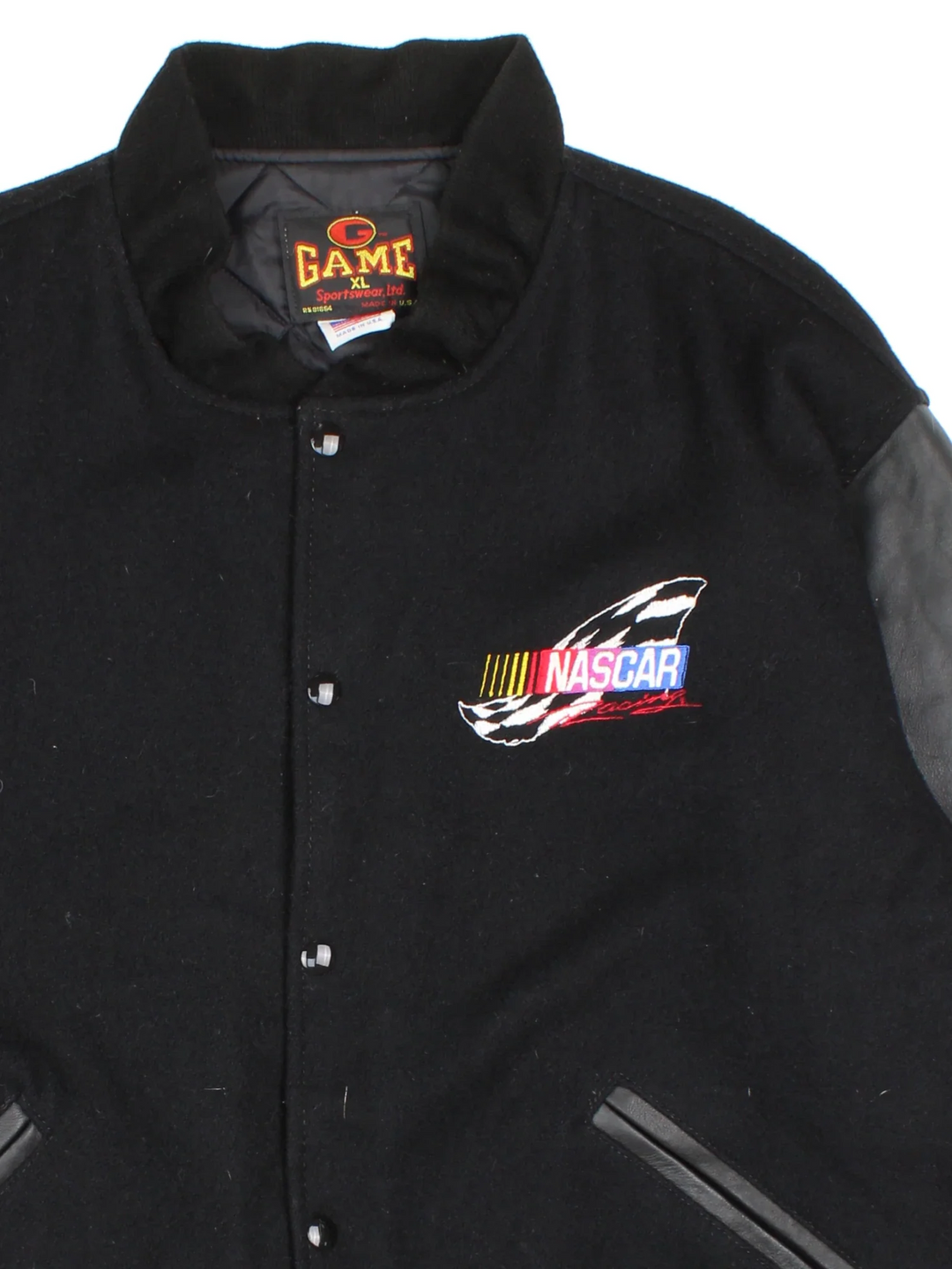 Vintage Nascar Varsity Jacket in a black colourway. Buttons up and has side pockets, quilted lining, and has the logo embroidered on the front and back.
