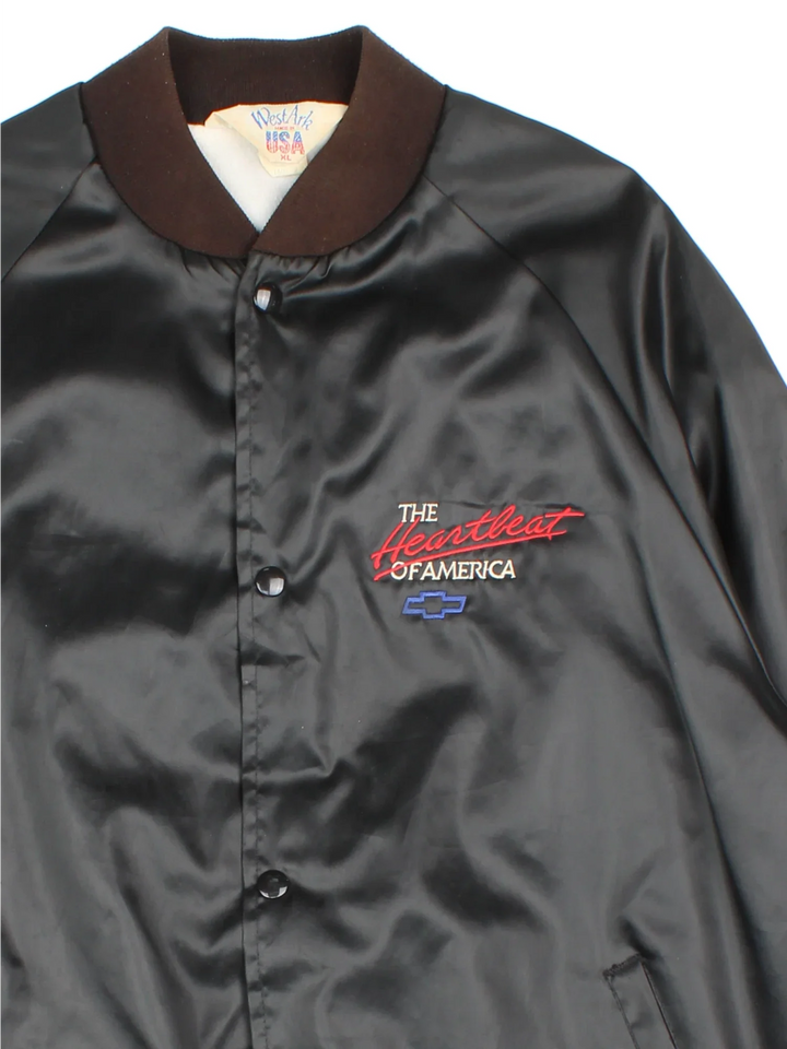 Vintage Chevrolet The Heart Of America Varsity Jacket in a black colourway. Buttons up and has side pockets, and the logo / spell out embroidered on the front and back.