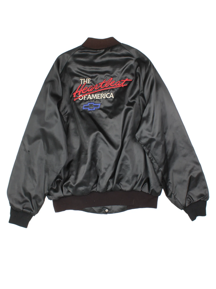 Vintage Chevrolet The Heart Of America Varsity Jacket in a black colourway. Buttons up and has side pockets, and the logo / spell out embroidered on the front and back.