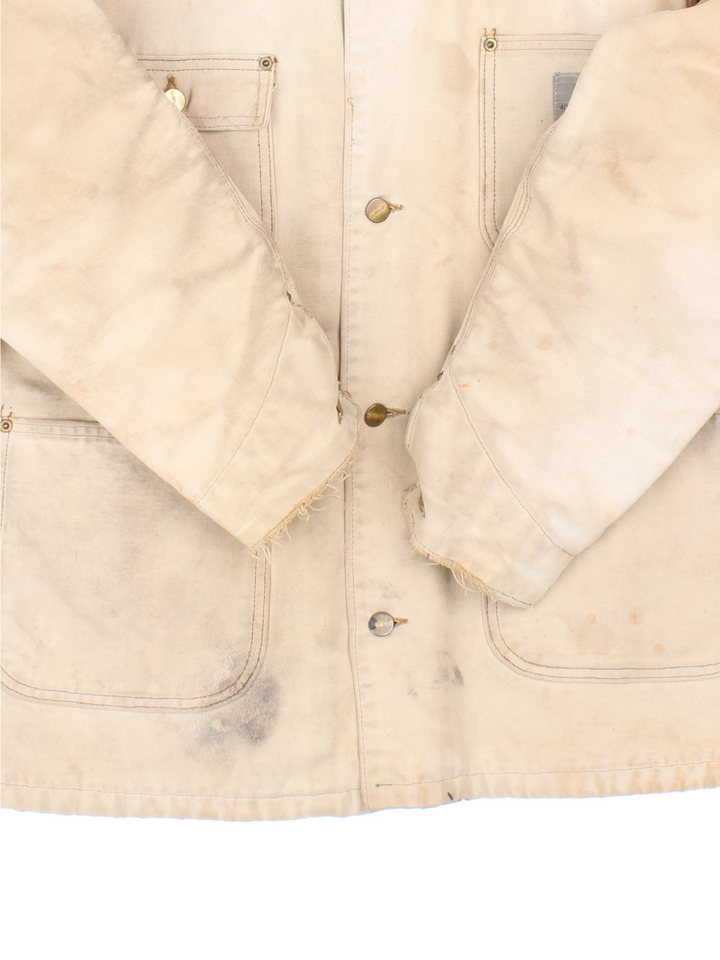 Vintage 70's Carhartt Distressed Chore Jacket in a tan colourway. Buttons up and has multiple pockets, blanket lining, corduroy collar, and has the logo embroidered on the front.