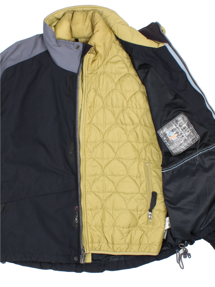 Nike ACG black and grey tech jacket. Features multiple pockets and zip in green quilted liner. 