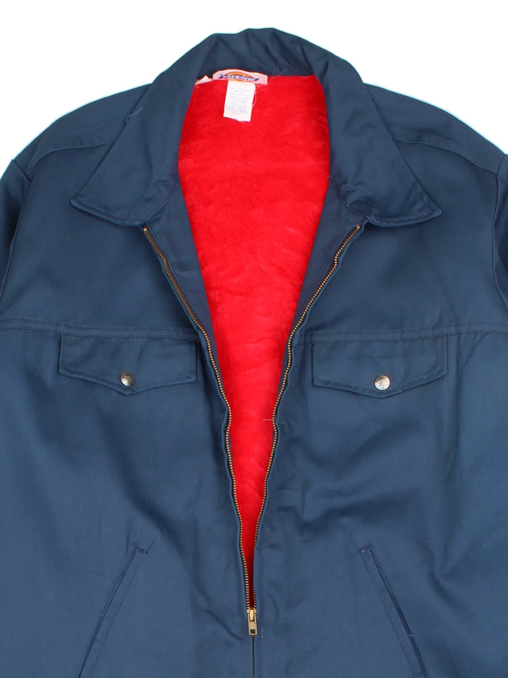 Dickies Sherpa Work Jacket in a blue colourway. Zip up closure and has multiple pockets, insulated with a sherpa lining.