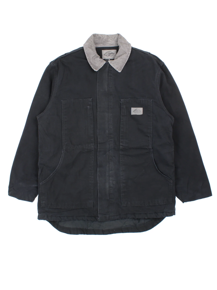 Dickies Chore Work Jacket in a black colourway with a grey corduroy collar. Zip up closure and has multiple pockets, insulated lining, and has the logo embroidered on the front.