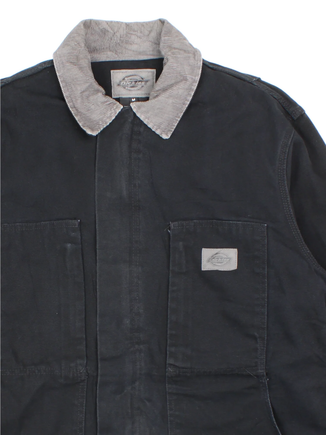 Dickies Chore Work Jacket in a black colourway with a grey corduroy collar. Zip up closure and has multiple pockets, insulated lining, and has the logo embroidered on the front.