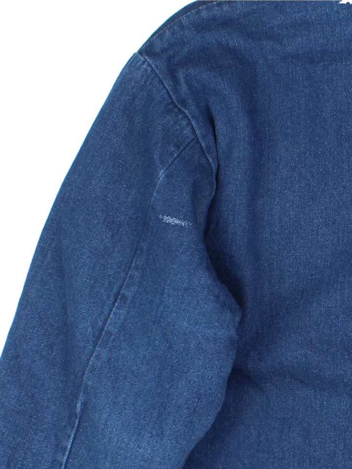 Vintage Denim Chore Jacket in a blue colourway with a black collar. Button up closure and has multiple pockets, insulated with a blanket lining.