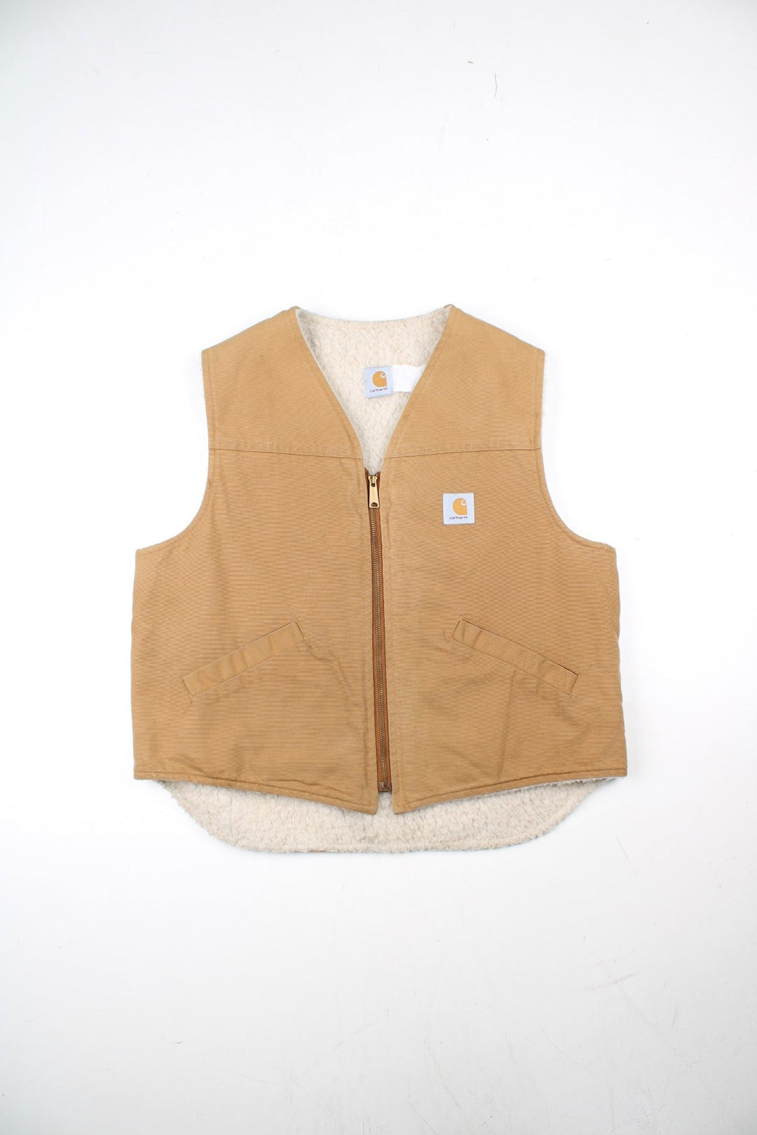 Vintage Carhartt Gilet in a tan colourway. Zip up with double pockets on front, insulated with a fleece lining and classic logo on the front.