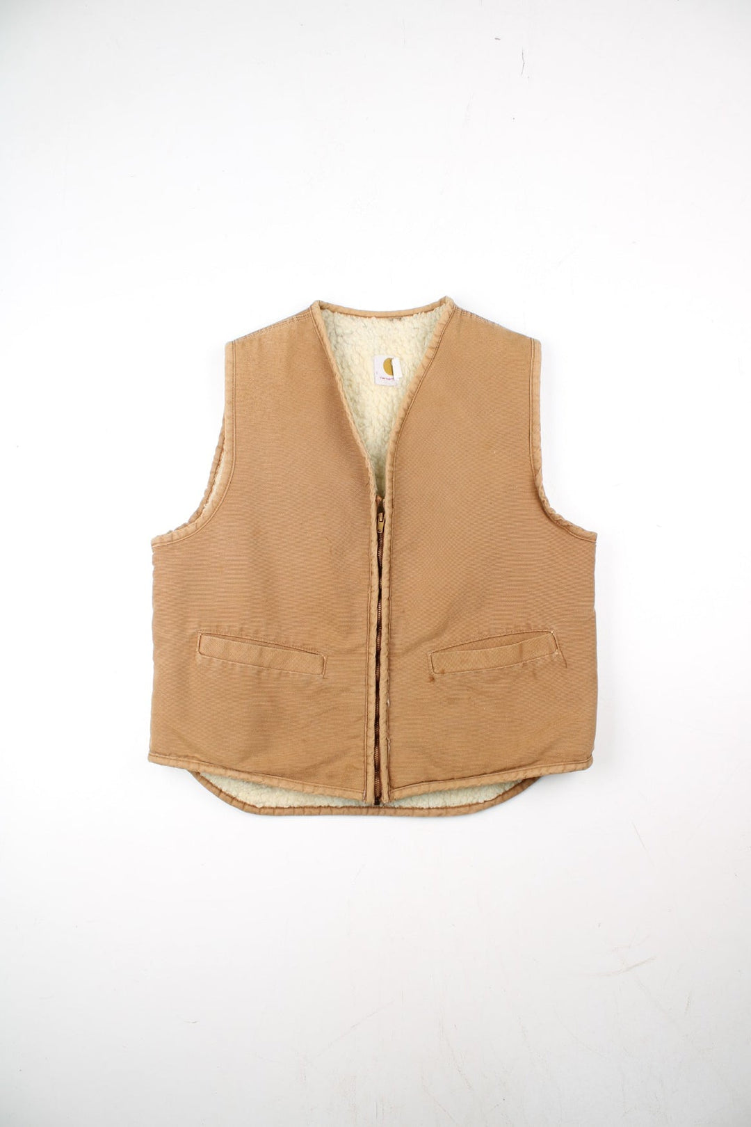 Vintage Carhartt Gilet in a tan colourway. Zip up with double pockets on front, insulated with a fleece lining.