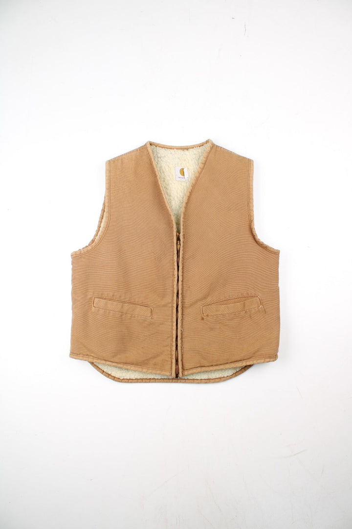 Vintage Carhartt Gilet in a tan colourway. Zip up with double pockets on front, insulated with a fleece lining.
