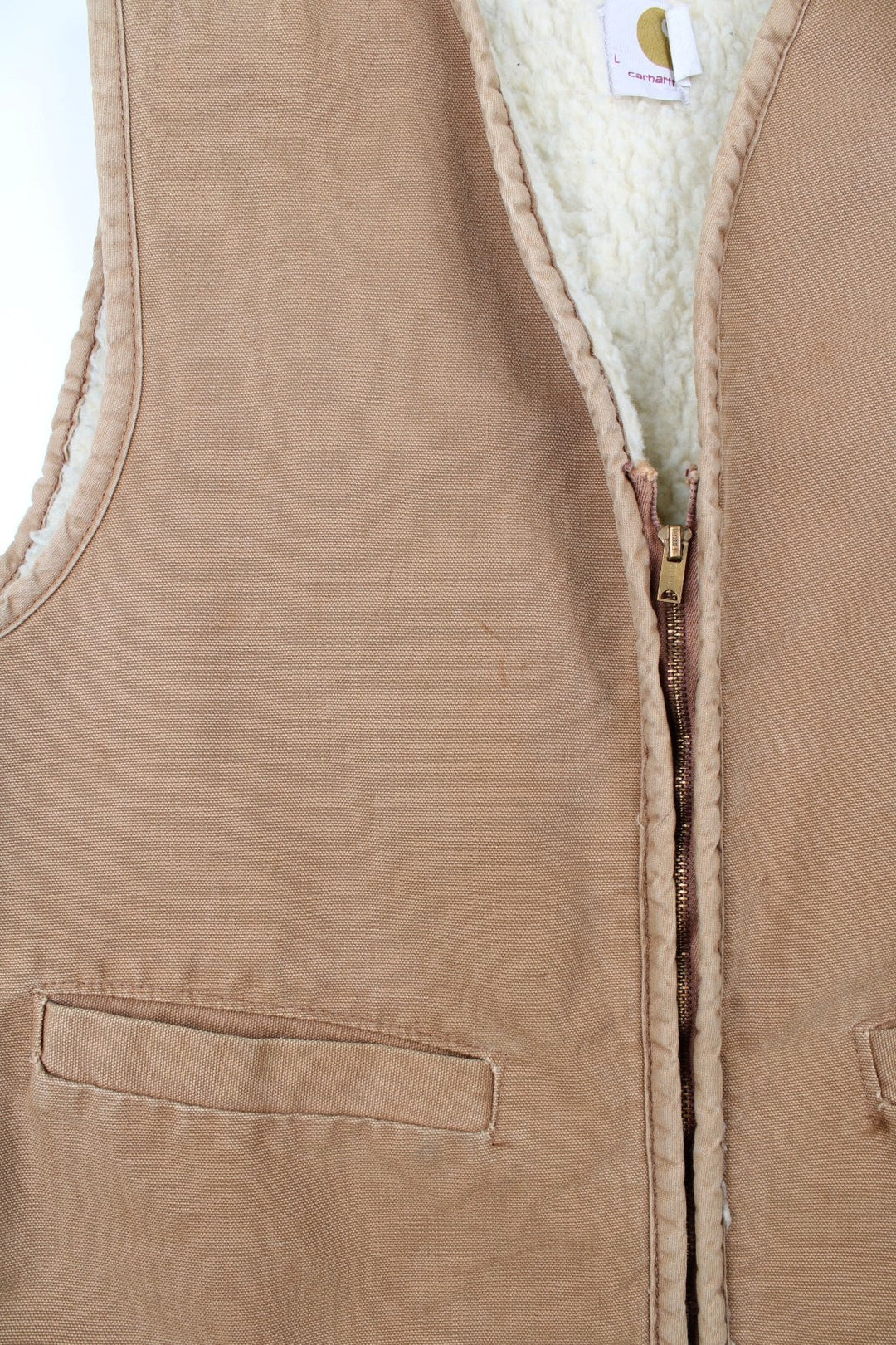 Vintage Carhartt Gilet in a tan colourway. Zip up with double pockets on front, insulated with a fleece lining.