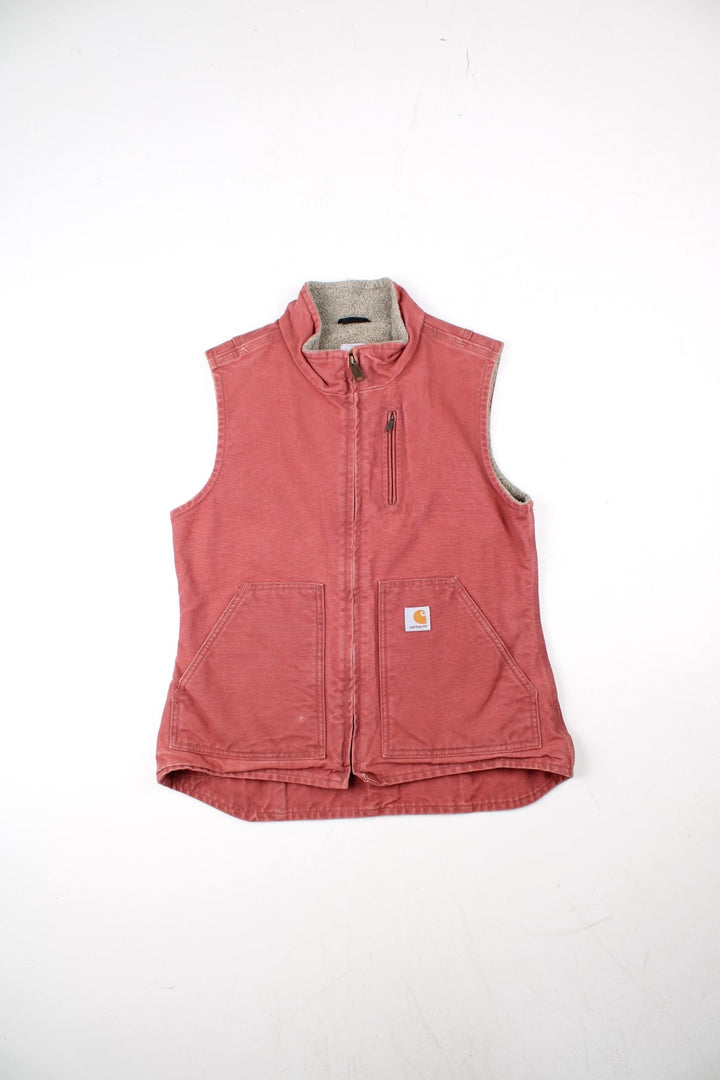 Vintage Carhartt Gilet in a pink colourway. Zip up with double pockets on front, insulated with a sherpa lining and classic logo on front.