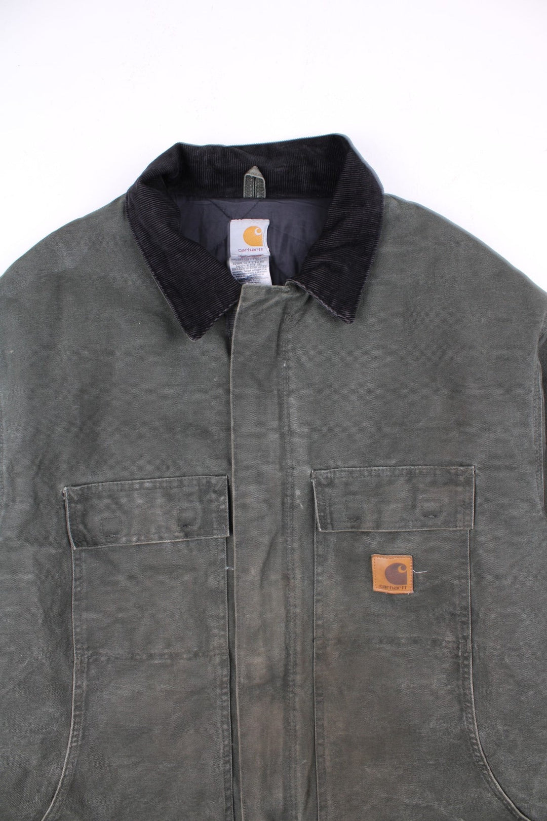 Carhartt Arctic Jacket in a green colourway with a black corduroy collar. Zips up and has multiple pockets, insulated with a quilted lining, and has the logo embroidered on the front.