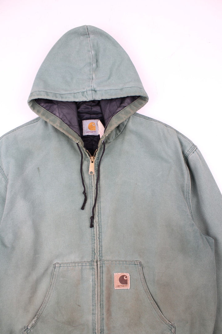Vintage Carhartt Active Jacket in a green colourway. Zips up and has side pockets, insulated with a quilted lining, and has the logo embroidered on the front.