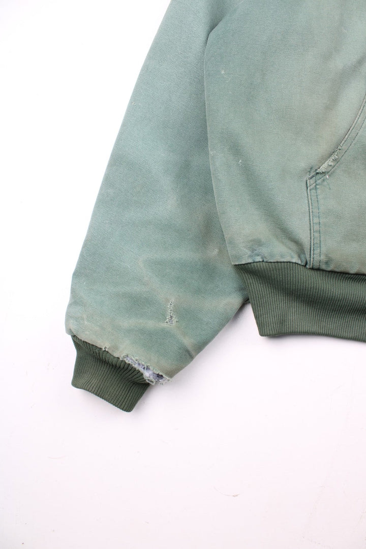 Vintage Carhartt Active Jacket in a green colourway. Zips up and has side pockets, insulated with a quilted lining, and has the logo embroidered on the front.
