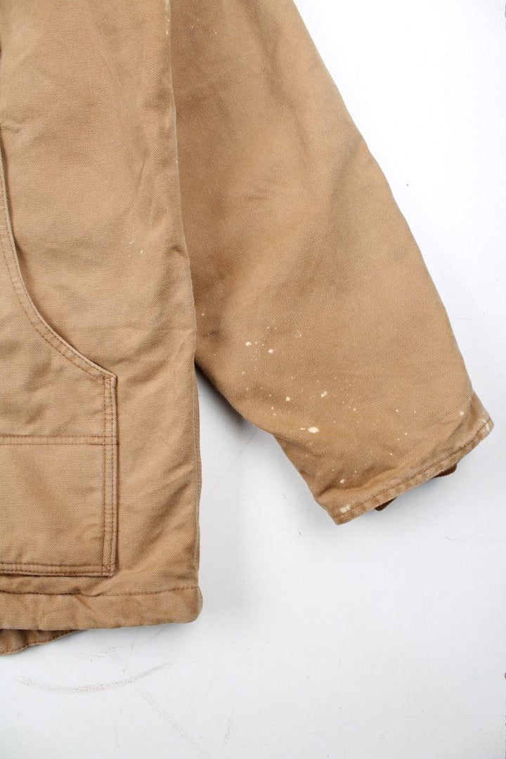 Vintage Carhartt Arctic Jacket in a tan brown colourway. Zips up and has multiple pockets, insulated with a quilted lining, and has the logo embroidered on the front.