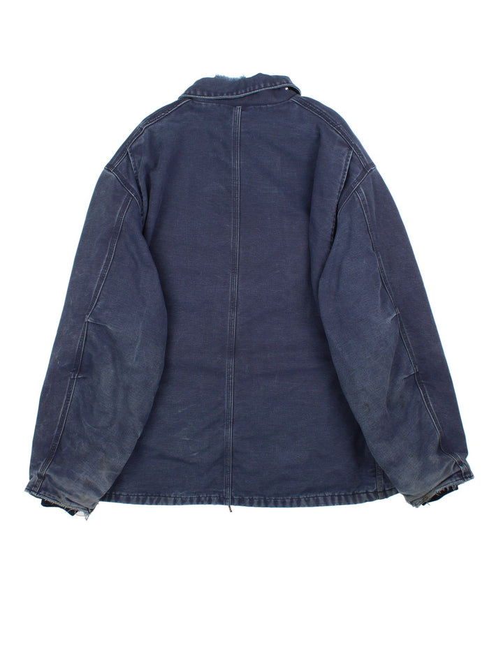 Vintage Carhartt Arctic Jacket in a blue colourway. Zips up and has multiple pockets, insulated with a quilted lining, and has the logo embroidered on the front.