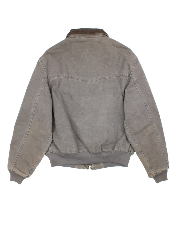 Vintage Carhartt Santa Fe Jacket in a grey colourway. Zips up and has side pockets, insulated lining, and has the logo embroidered on the front.