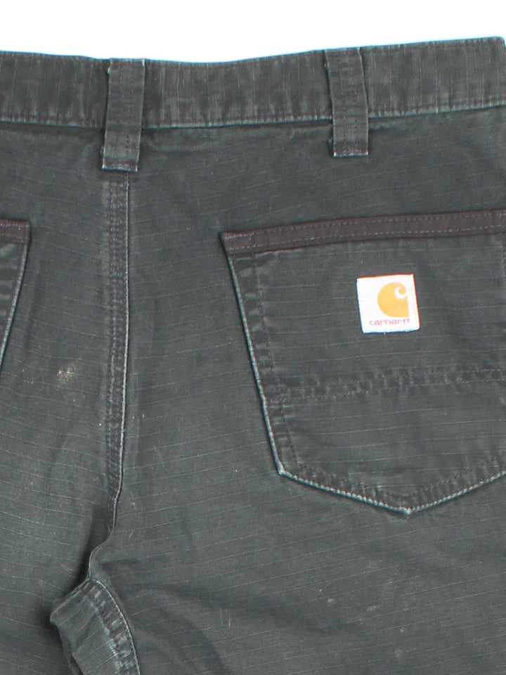 Carhartt Cargo Trousers in a black colourway with multiple pockets and the logo embroidered on the back.