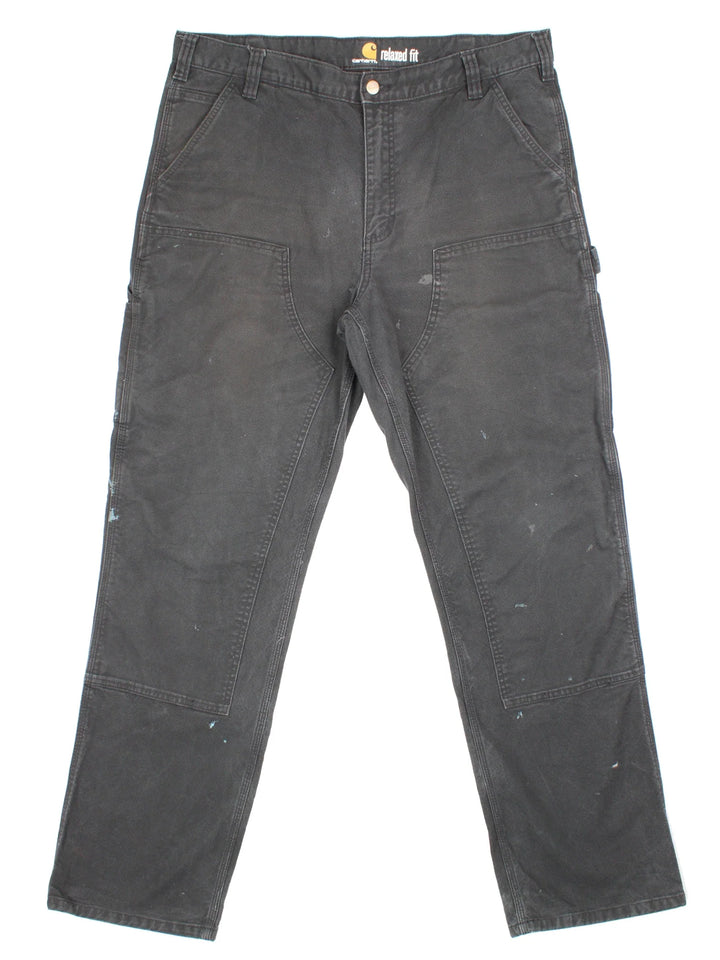 Carhartt Double Knee Jeans in a black colourway with multiple pockets and the logo embroidered on the back.