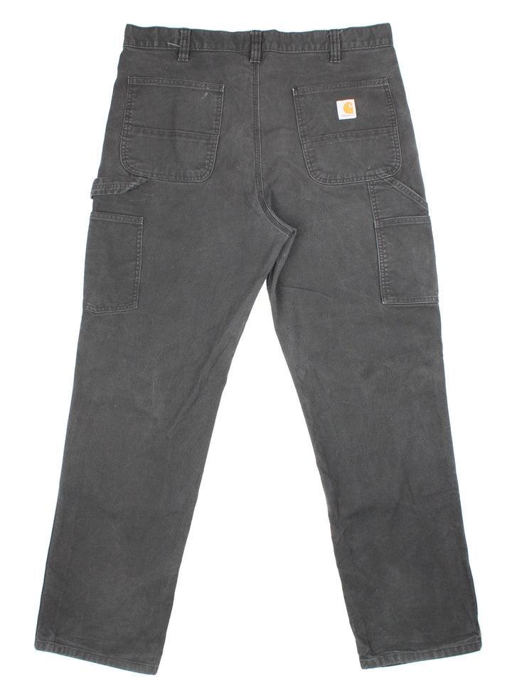 Carhartt Double Knee Jeans in a black colourway with multiple pockets and the logo embroidered on the back.