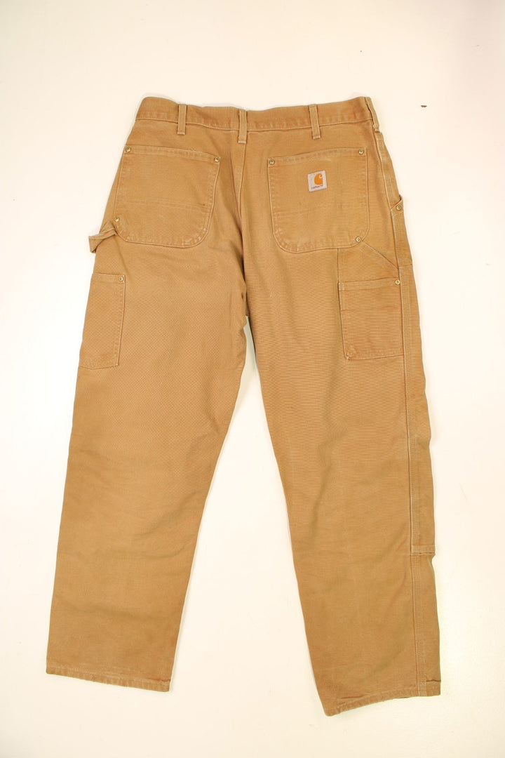 Carhartt Double Knee Jeans in a brown colourway with multiple pockets and the logo embroidered on the back.