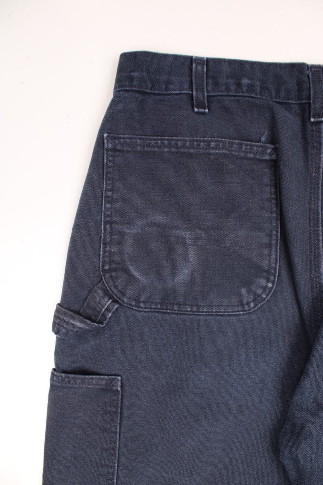 Carhartt black carpenter jeans with front, back and side pockets, a hammer loop, and a logo patch on the back pocket. 