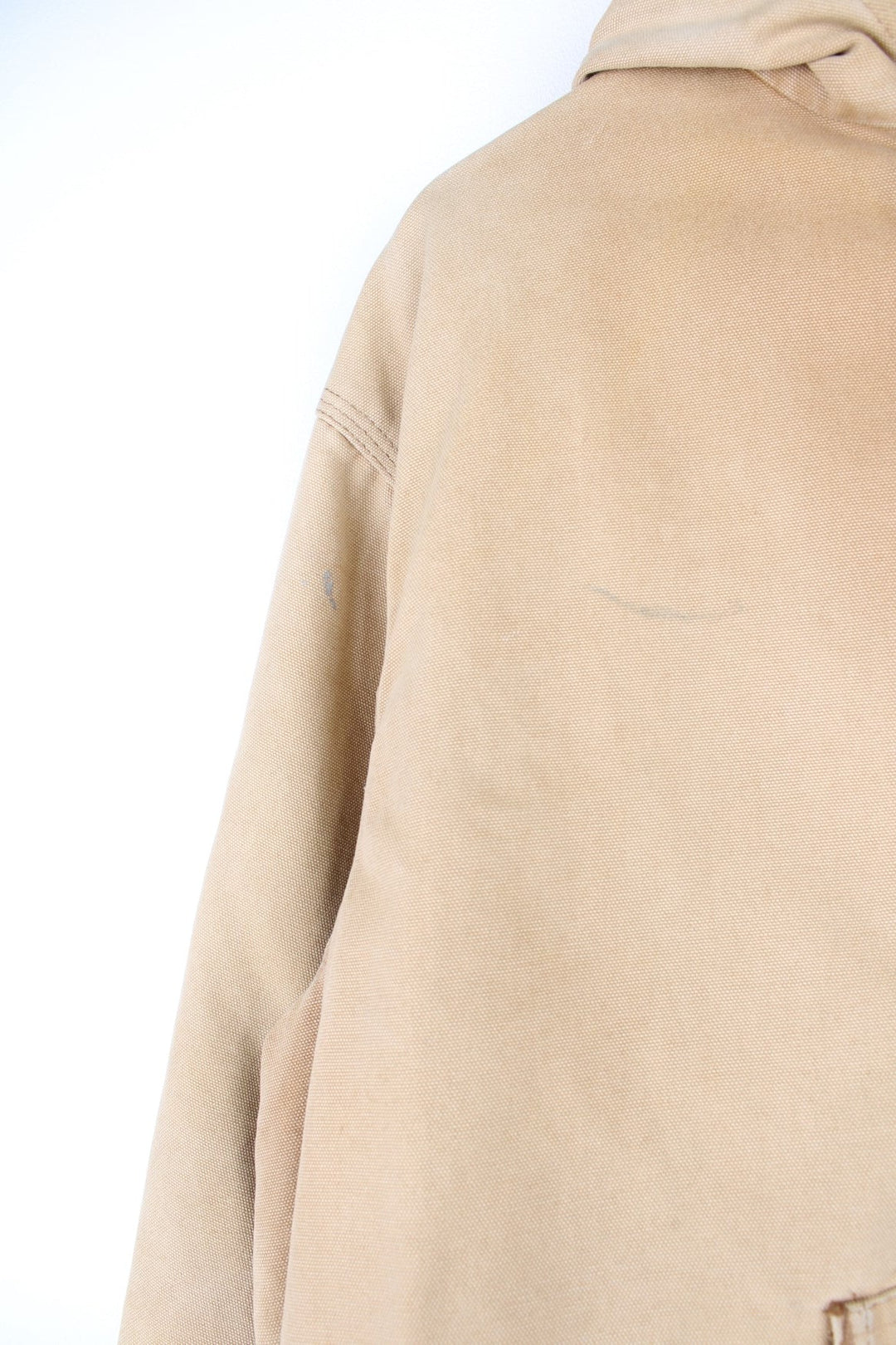 Vintage Carhartt Active Hooded Jacket in a tan colourway. The jacket has two front pockets, a gold zip to close and the Carhartt logo stitched onto the front. 