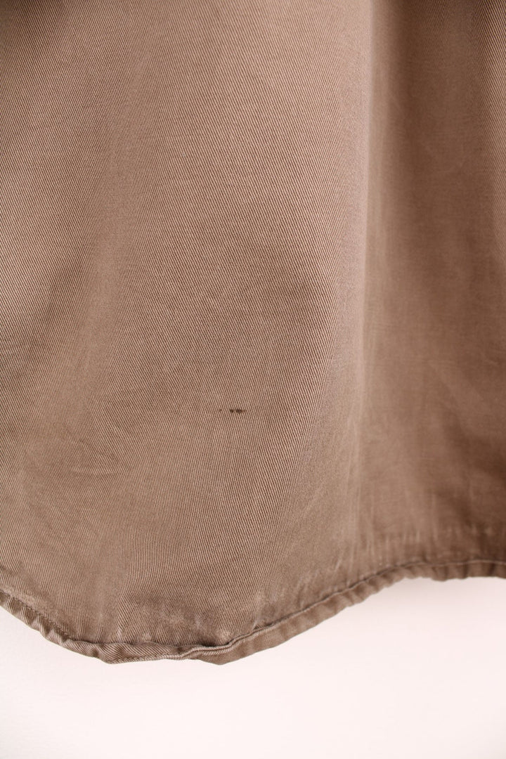 Carhartt brown canvas shirt. Features chest pockets and embroidered leather logo.