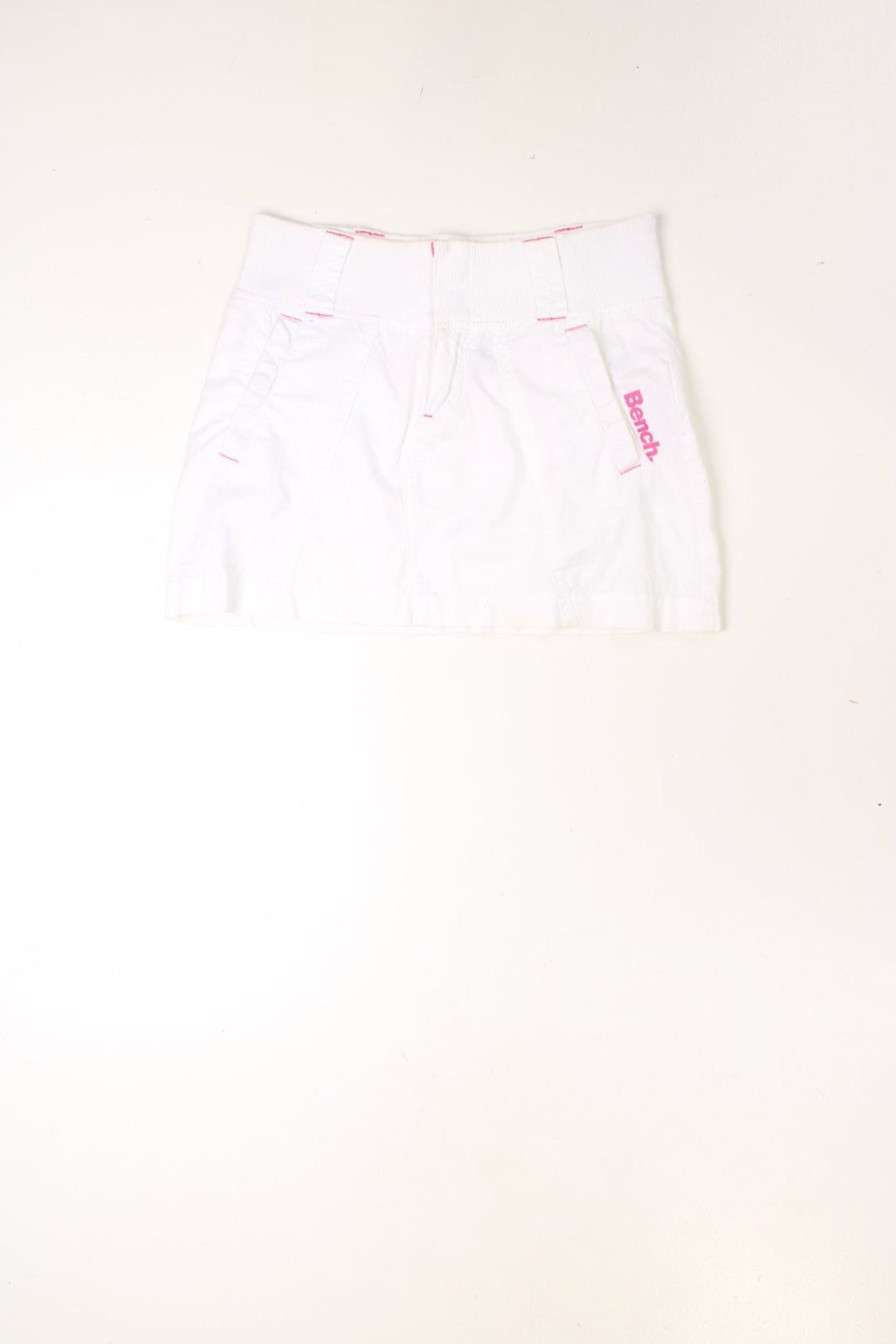 Y2K white and pink, Bench mini skirt. Features printed logo, and embroidered detailing on the pocket.