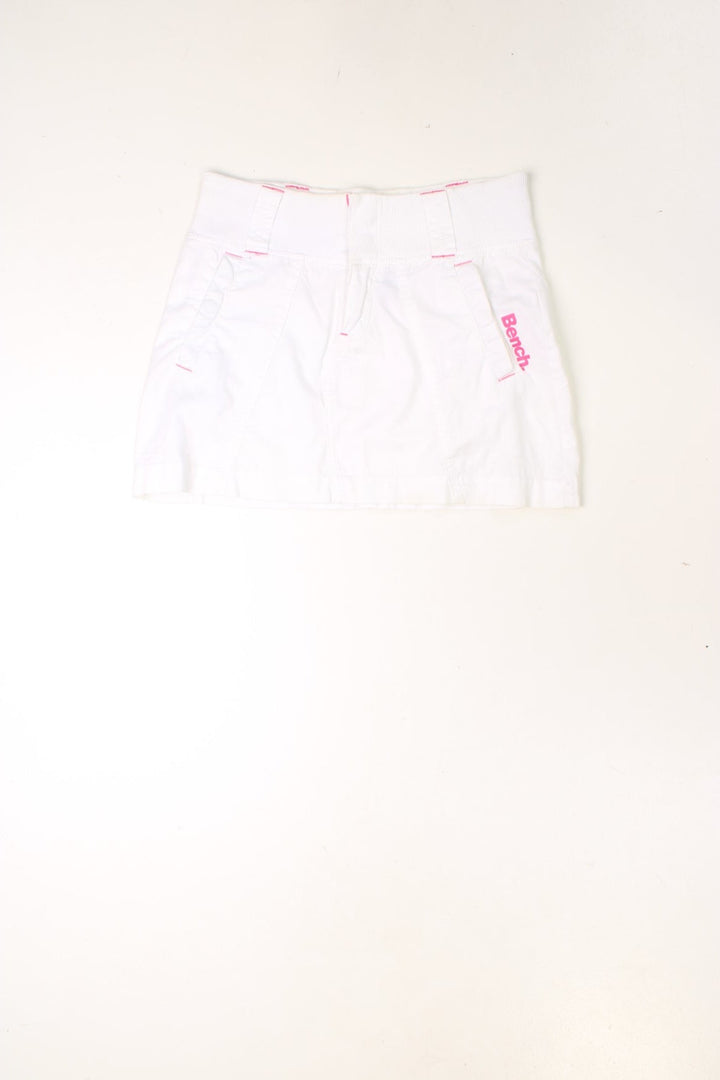 Y2K white and pink, Bench mini skirt. Features printed logo, and embroidered detailing on the pocket.