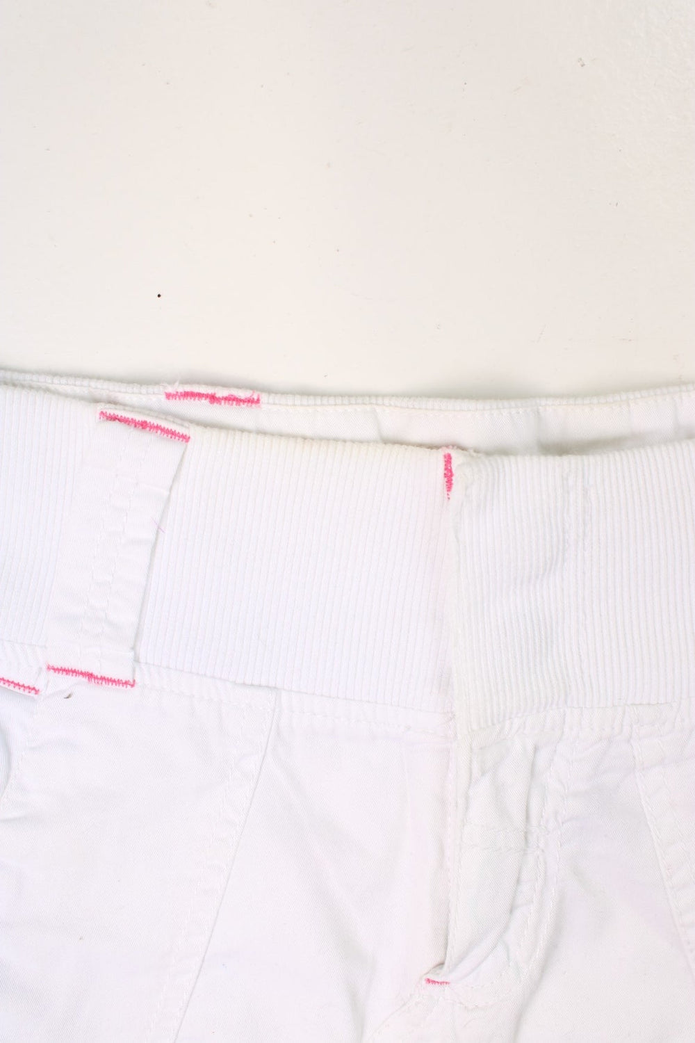 Y2K white and pink, Bench mini skirt. Features printed logo, and embroidered detailing on the pocket.