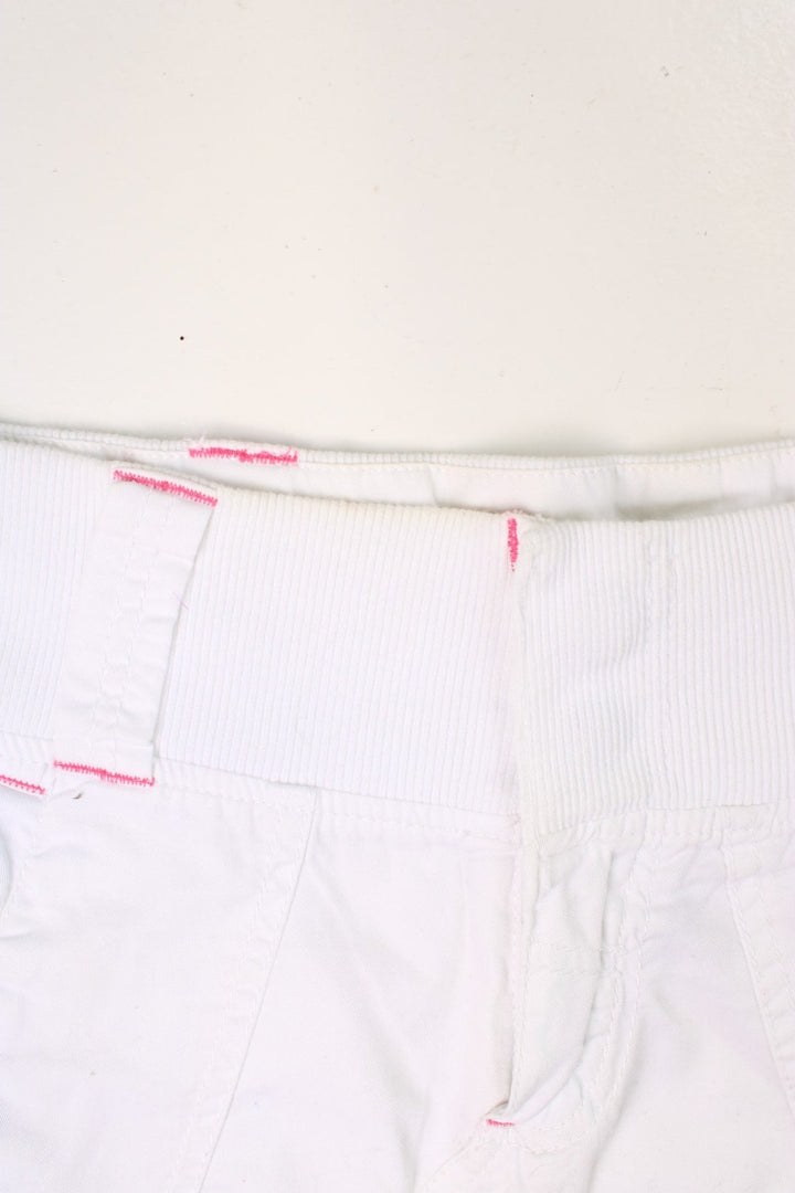 Y2K white and pink, Bench mini skirt. Features printed logo, and embroidered detailing on the pocket.