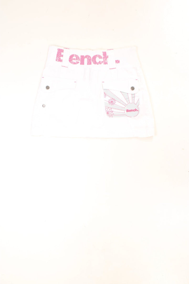 Y2K white and pink, Bench mini skirt. Features printed logo, and embroidered detailing on the pocket.