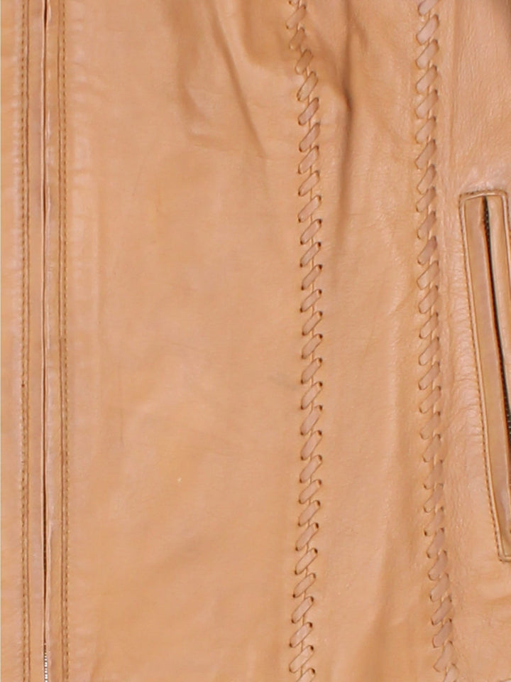 Vintage Western Style Leather Jacket in a tan colourway, zips up and has side pockets, and has cross stitching features going down the sides.