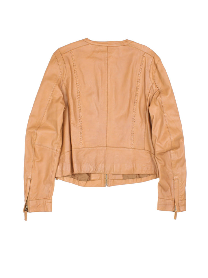 Vintage Western Style Leather Jacket in a tan colourway, zips up and has side pockets, and has cross stitching features going down the sides.