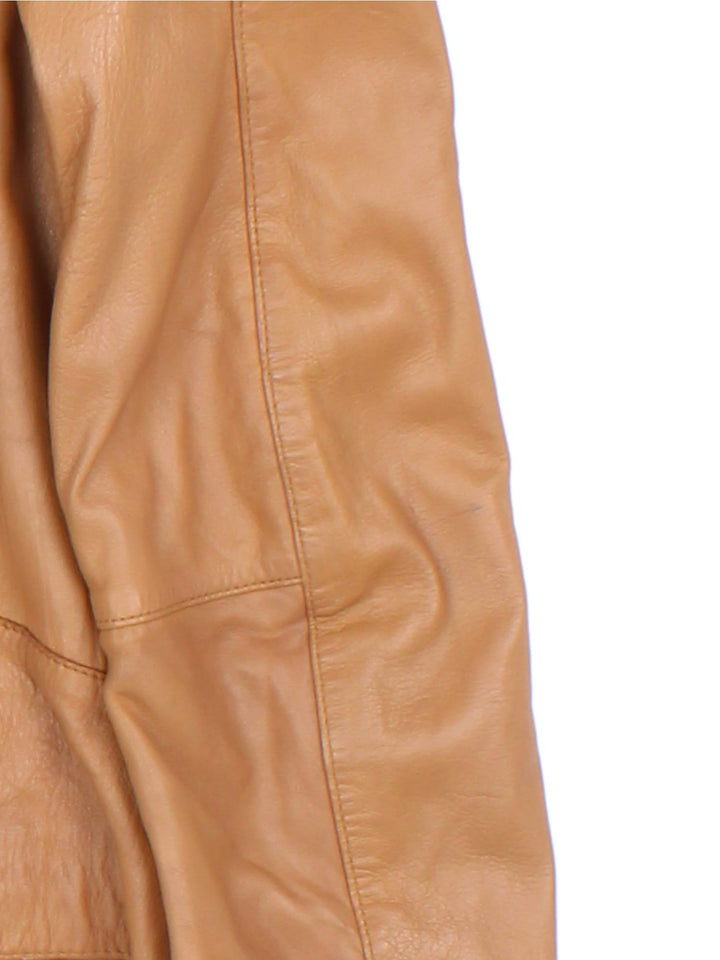 Vintage Western Style Leather Jacket in a tan colourway, zips up and has side pockets, and has cross stitching features going down the sides.