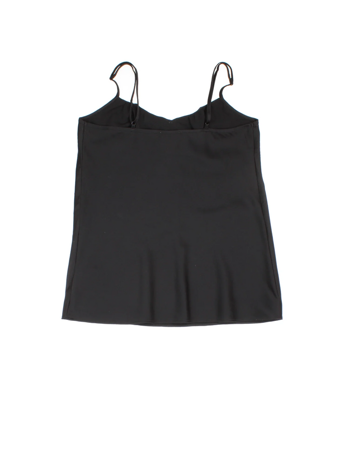 Y2K Bow Vest in a black/white colourway. Adjustable straps, bow detail and frill hemline.